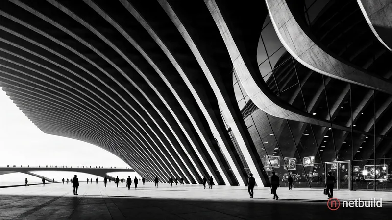 Dramatic black and white architectural photography of a sweeping ribbed concrete structure merging with a sleek glass facade. Low-angle perspective fr...